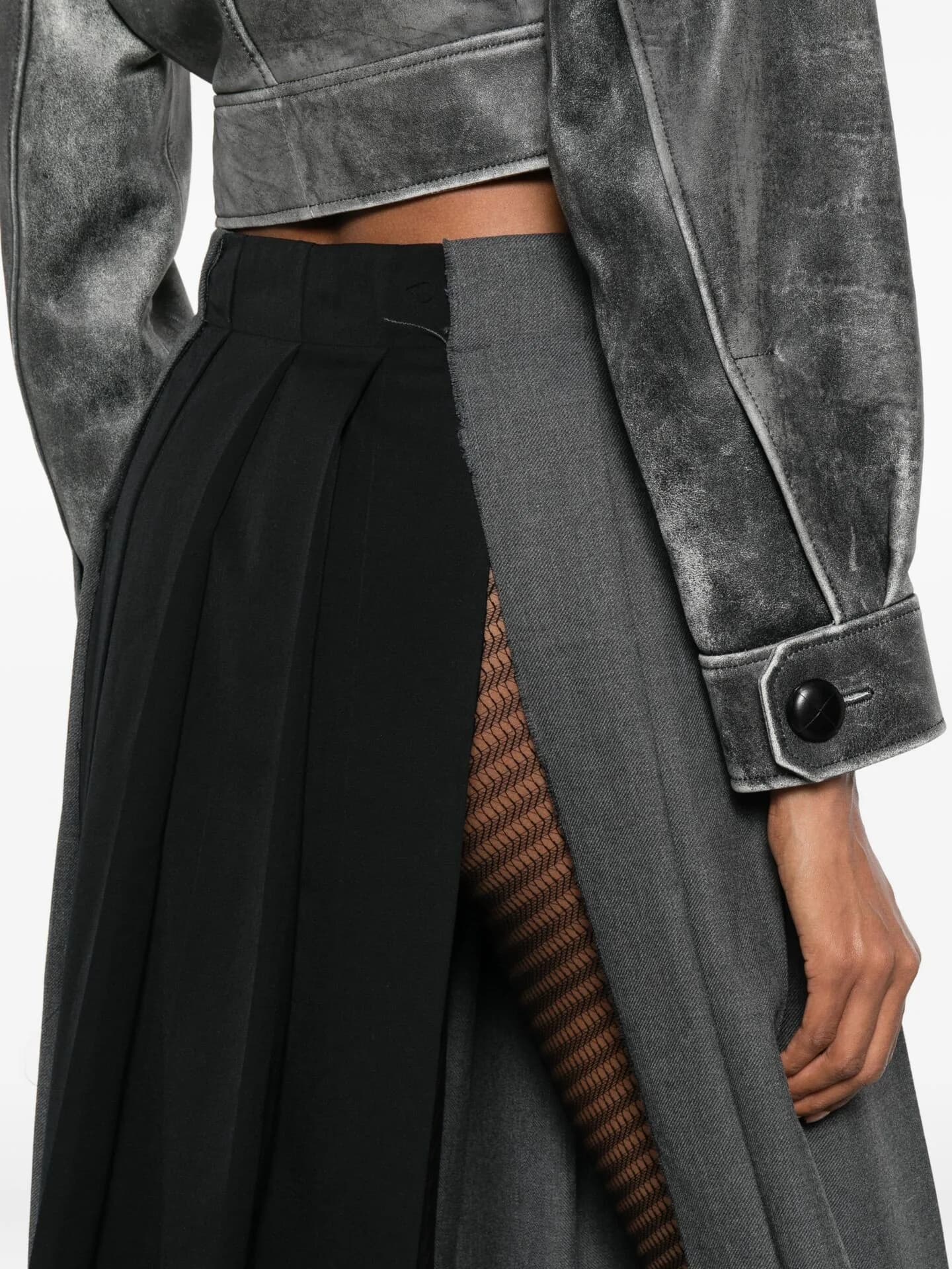 Distressed silver leather jacket worn with a black pleated skirt