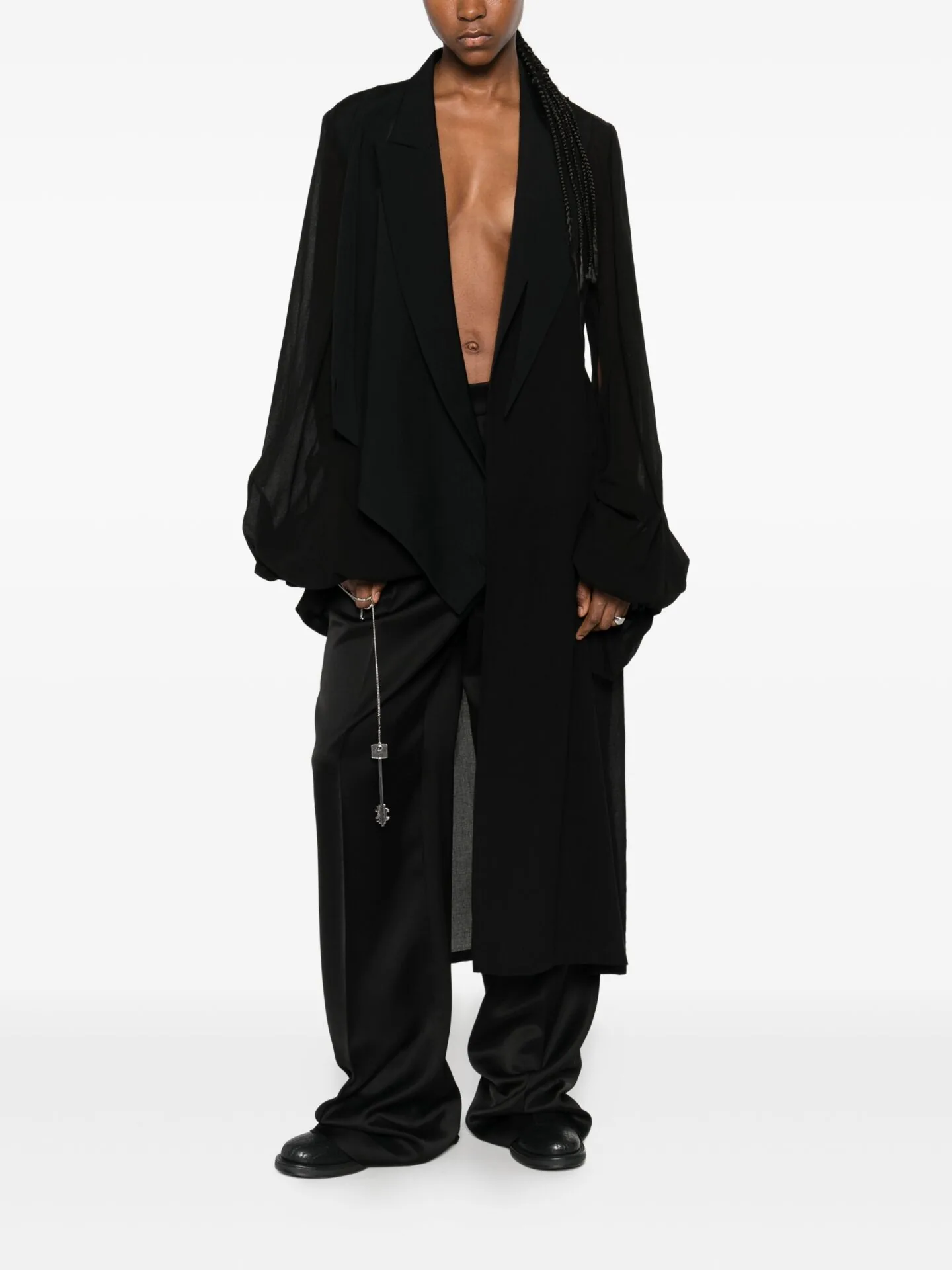 Long black draped coat over wide black trousers
